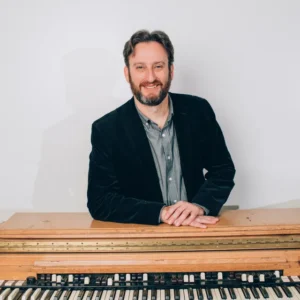 Brian Felix Smile Behind Organ.jpg sqXl